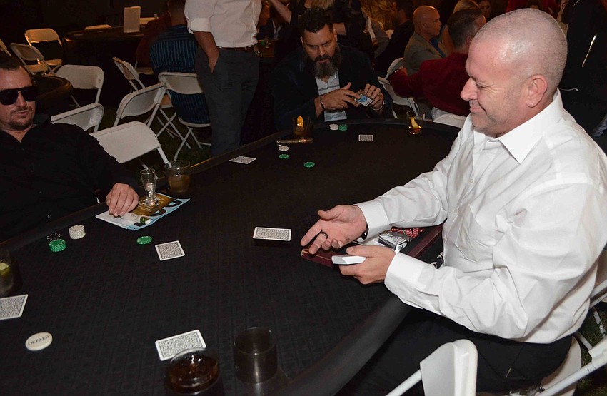 Patrick Thomas deals a hand to his players.