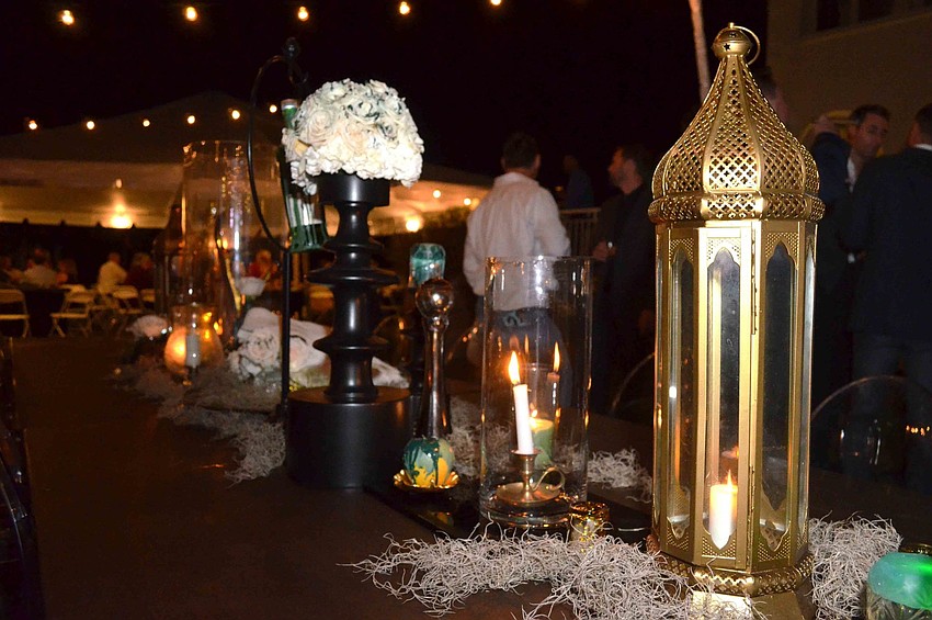 Eccentric centerpieces by So Staged Event Rentals adorn every table.