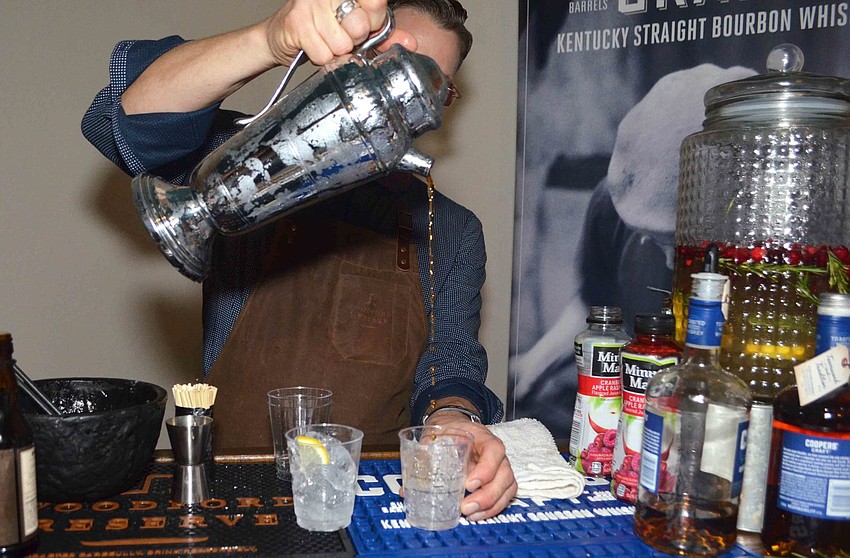 Michael J. Ring makes an Old Fashioned for one of the attendees.