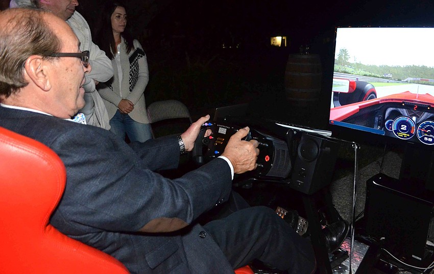 Fran Misantone takes a ride on the race car simulator.