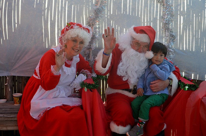 Luke Calijan, 2, smiles with Santa and Mrs. Claus. Santa took a break from the North Pole to visit The Old Salty Dog on Dec. 17.