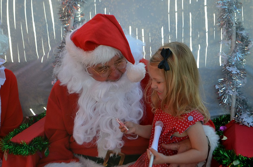 Olivia Rowley,3, smiles as she talks with Santa Claus. Santa took a break from the North Pole to visit The Old Salty Dog on Dec. 17.