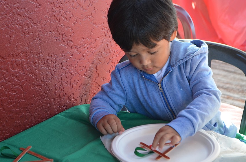 Luke Calijan, 2, makes a reindeer craft at The Old Salty Dog on Dec. 17. Santa and Mrs. Claus took a trip down from the North Pole to have breakfast and visit with customers.