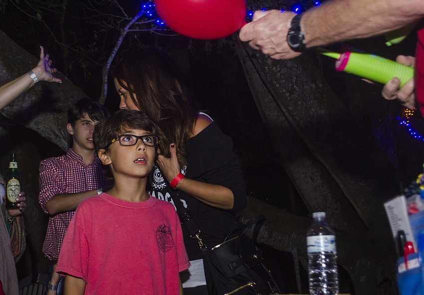 Benjamin Lalo watches as his balloon animal is made.