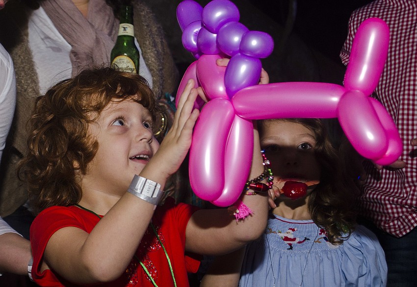 Eve Rollins reacts to getting a pink balloon unicorn.