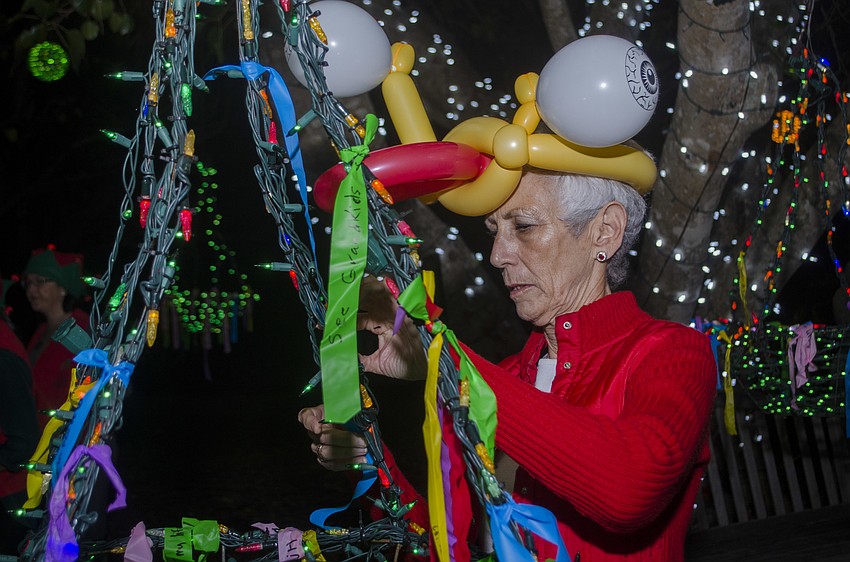 Fran Moran ties her wish to the wishing tree.