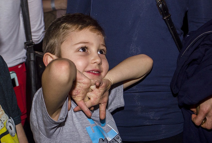 Miles Craddock watches as his balloon animal is made.