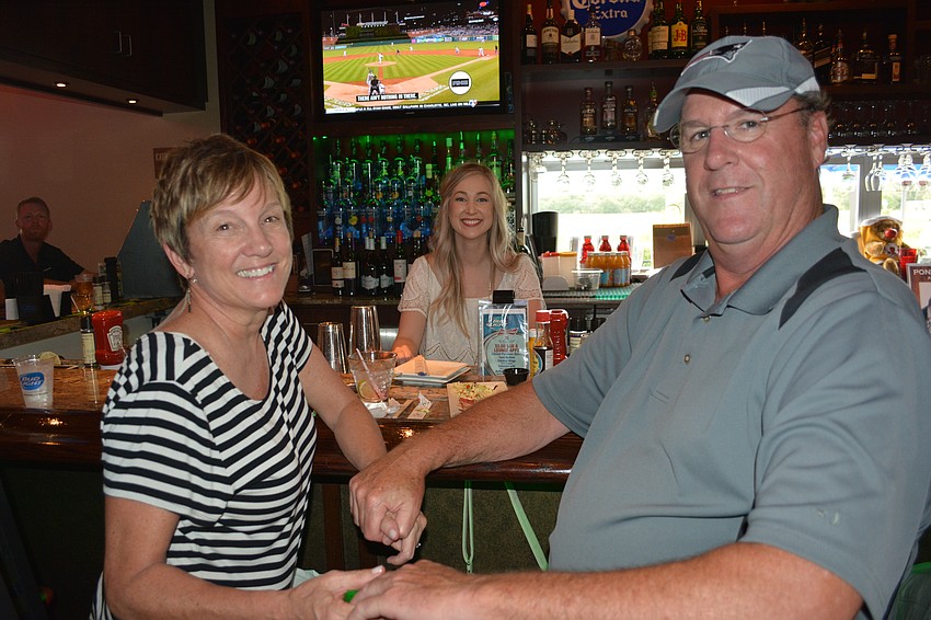 Carolyn and Brian Kelly supported the effort while Cheers for Charity founder Amanda Tullidge, back, works as a guest bartender.