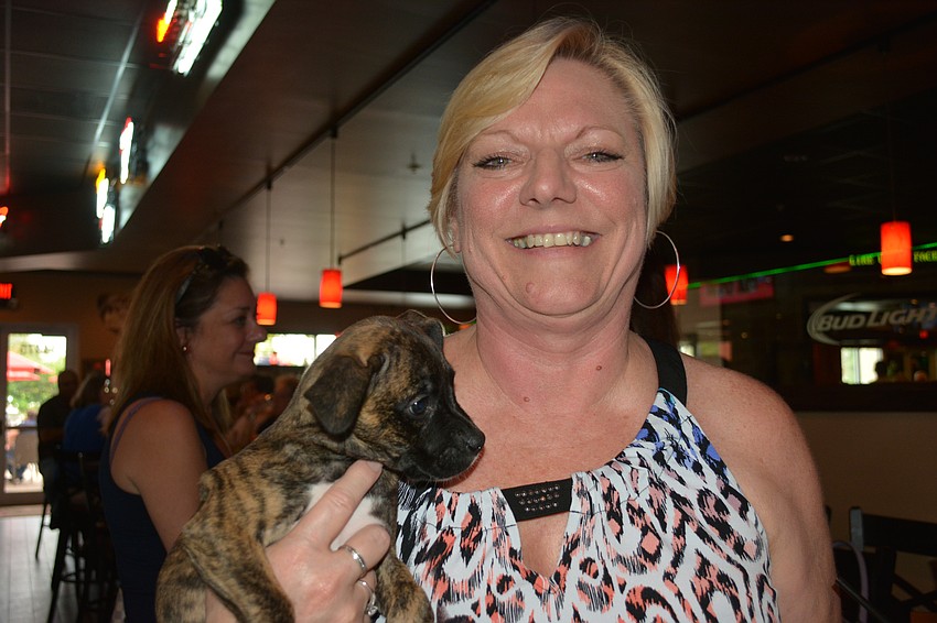 Cheryl Rice, a volunteer at Nate's shows off Blakely, an 8-week-old boxer-pit bull mix.
