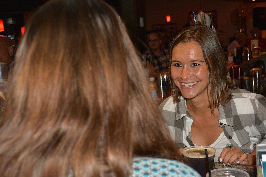 Cheers for Charity's Erin Vanderveen enjoys her shift as a bartender during the fundraiser.
