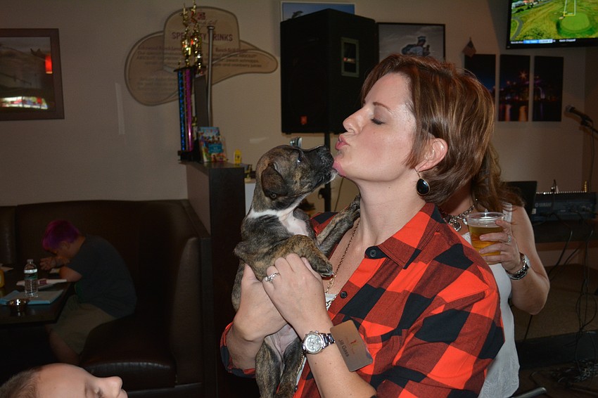 Cheers for Charity member Jill Gass visits with Brielle, an 8-week-old boxer, pit bull mix.
