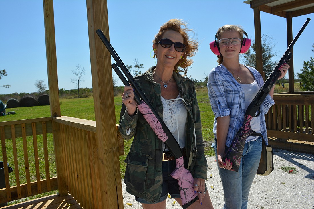 Michelle Bianchi-Pingel of The Players Center for Performing Arts, and Carli Kasten, daughter of LWRBA director Heather Kasten, show off a pair of pink Mossberg 20 gauge shotguns.