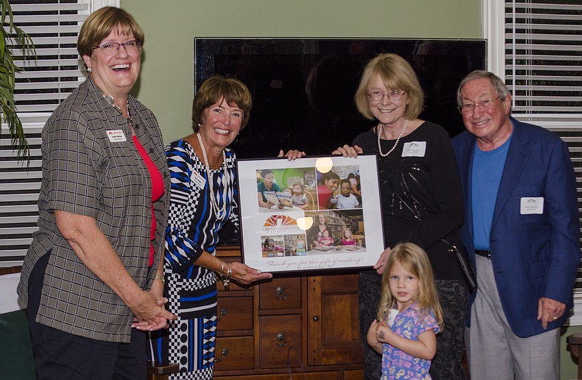 President of the Library Foundation Linda Getzen and Executive Director Suzanne Seiter present board members Pat and Bob Gussin with a plaque  to commemorate their generosity in the Children'         s Literacy Endowment fundraiser.
