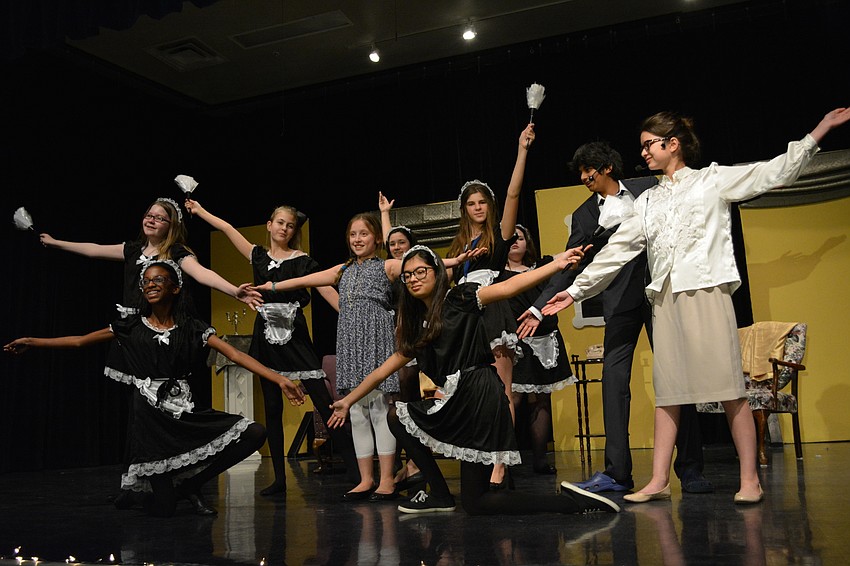 Maids and staff at the Warbucks mansion welcome orphan Annie to her new home.