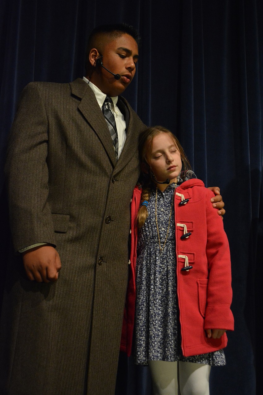Oliver Warbucks, played by Marcus Gonzalez, walks with Annie (Ellie Smyth) home from a show.
