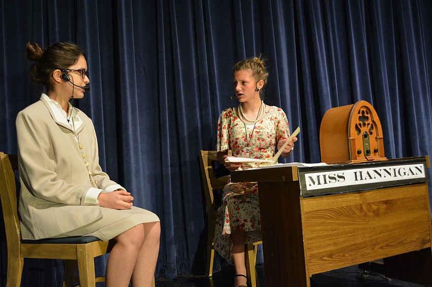 Grace Farrell, played by Loganne Digma, tells Miss Hannagan (Hallie Monserez) that her employer, Mr. Oliver Warbucks, wants to adopt the orphan Annie.