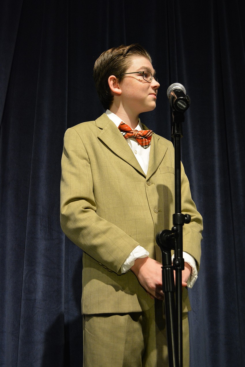 Jackson Day, as Bert Healy, hosts Oliver Warbucks and Annie on his radio program.