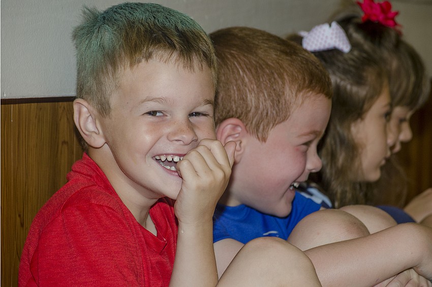 Gage Walker laughs as Michelle Marano reads 