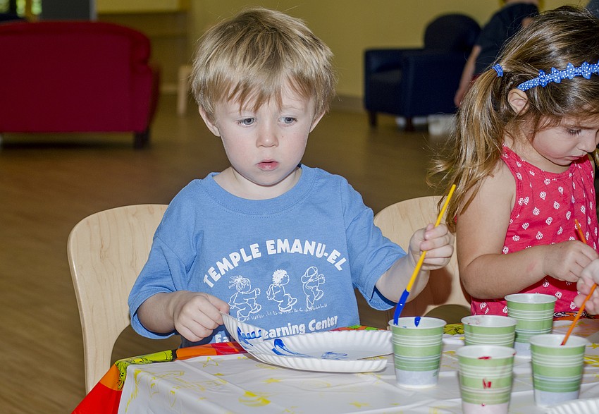 Liam Morgan paints blue fish.