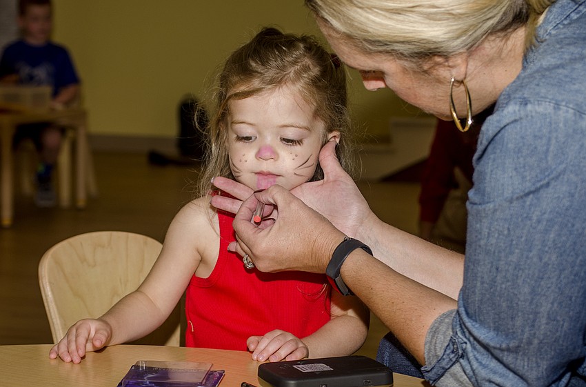 Emma Kayser gets her face painted.