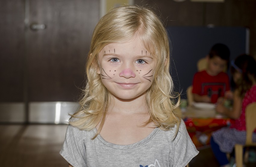 Skylar Cooksey smiles after getting her face painted.