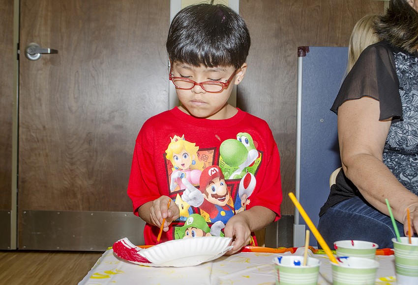 Samantha Pablo-Soreque paints her red fish.