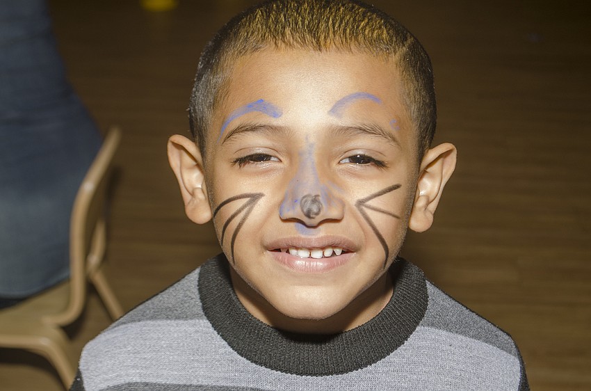 Daniel Moreno smiles after getting her face painted.