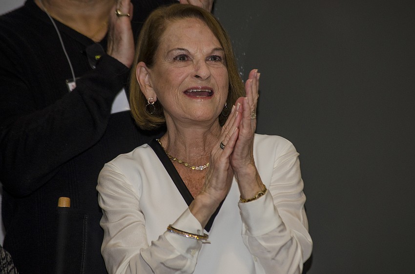 Barbara Basch welcomes glass artist Richard Royal to the ceremony. Royal later performed the inaugural glass blowing demonstration.