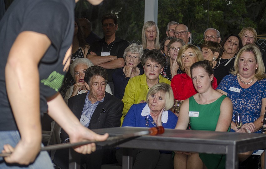 Guests watch a glass blowing demonstration.