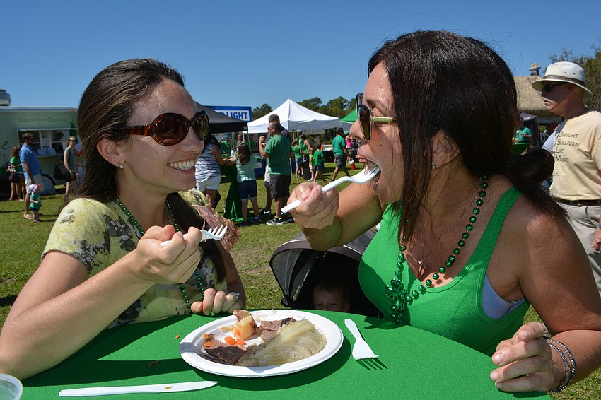 Lakewood Ranch'  s Rachel Hibbert and Lori Ziegler share corned beef and cabbage during the Irish Celtic Festival.