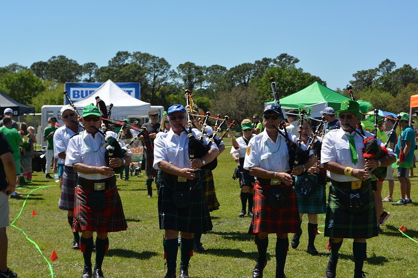 Pipers from Lion Rampart Pipe and Drum lead the Lucky Dog Parade.