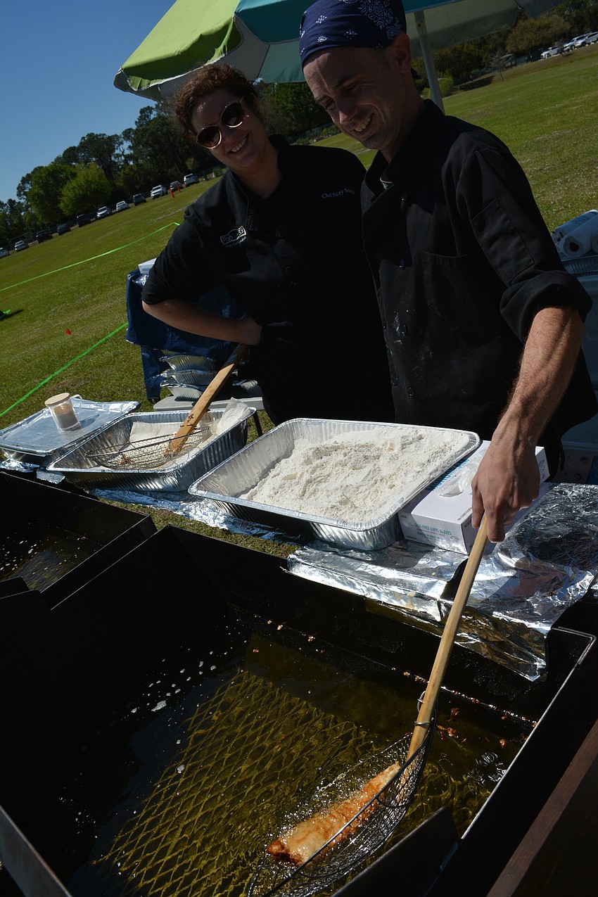 Chef Suzy Smith and volunteer Sean Marks prepare fish and chips for Pub 32 at the Irish Celtic Festival.