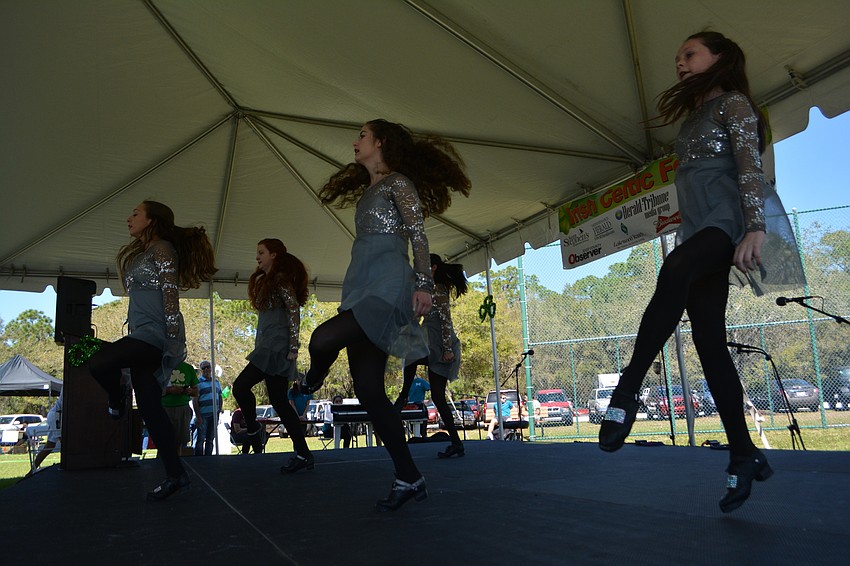 Performers for the Drake School of Irish Dance pound the stage while doing an Irish dance.