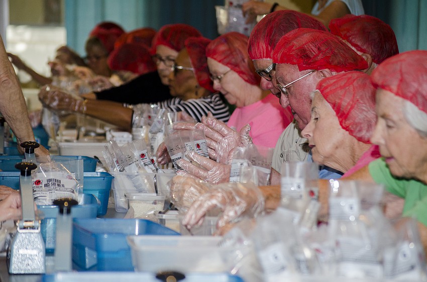 Volunteers sealed bags of food at St. Boniface Church.