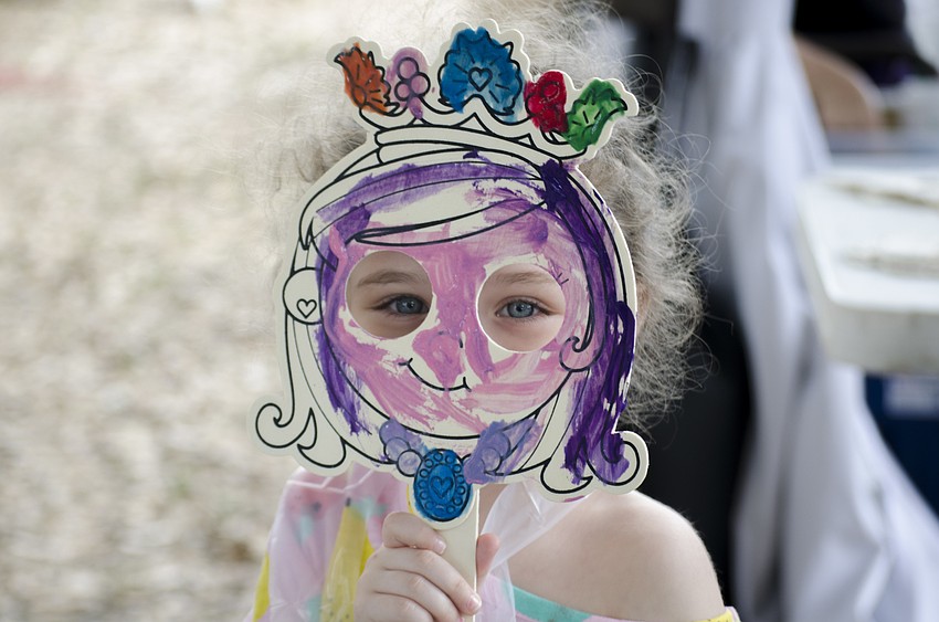 Kali Baran shows off the mask she painted during the festival.