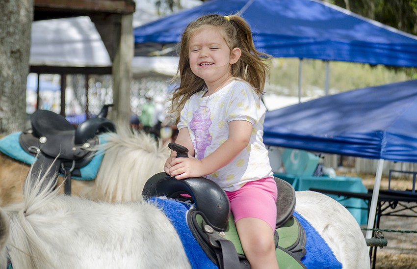 Julia Henson rides on the pony ride.