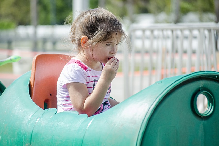 Isabella Saboya eats a strawberry on one of the rides at the Berry Festival.