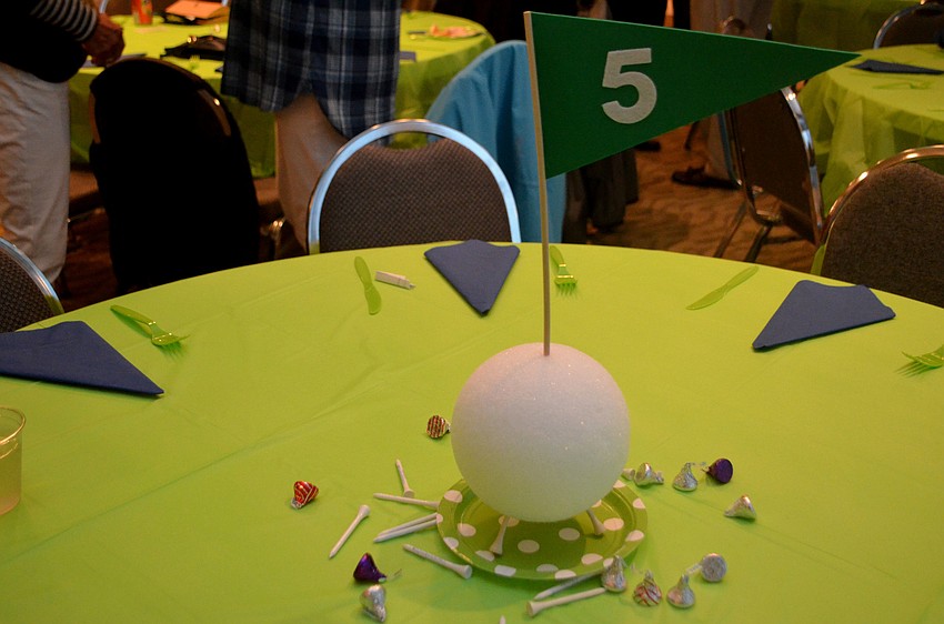 The tables were decorated with golf-themed centerpieces.