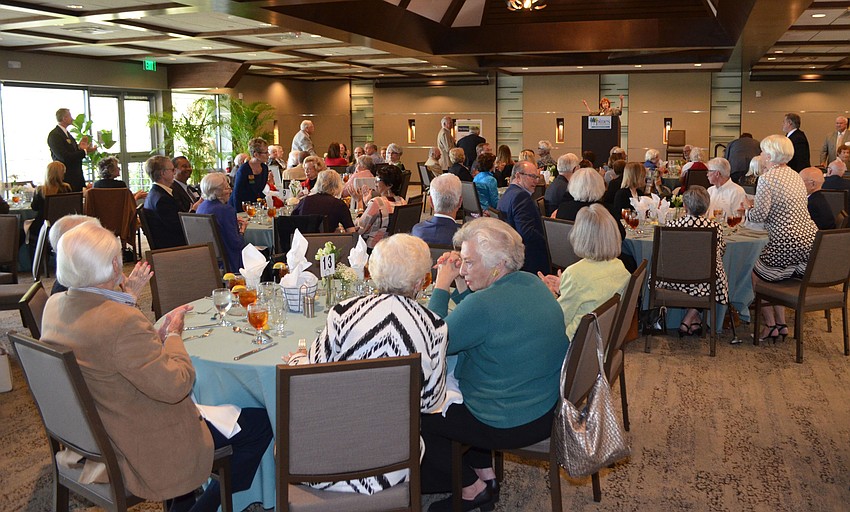 President of Pines of Sarasota Foundation Estelle Crawford invites board members to stand at the Giving Tree Society Luncheon on March 14 at Michael’s on the Bay.