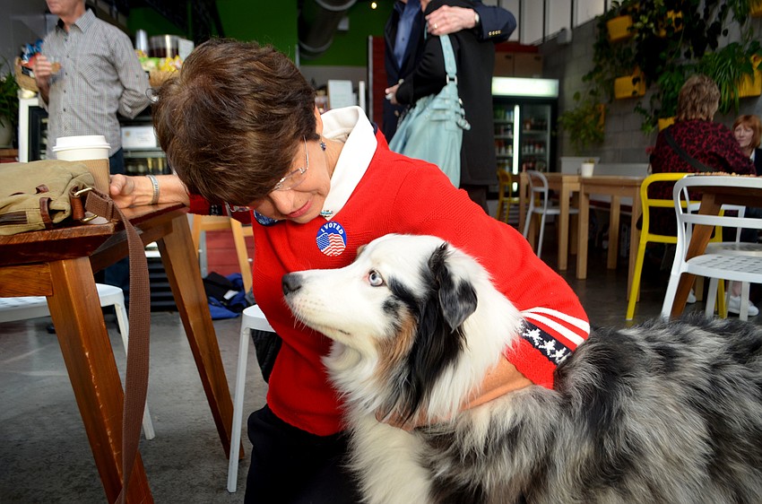 City Commissioner Susan Chapman hugs Bindi while she awaits election results.