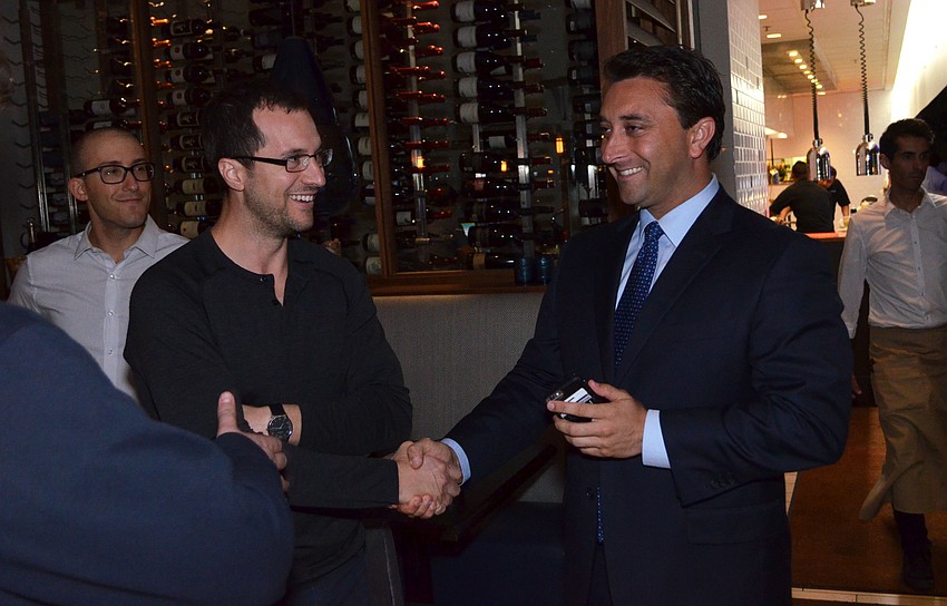 Damien Blumetti shakes hands with Hagen Brody after hearing the final results.