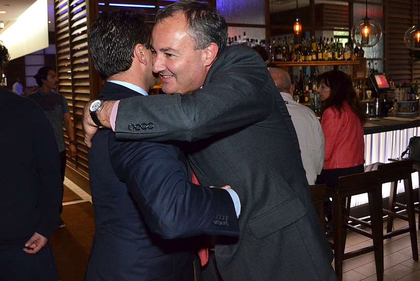 Martin Garcia hugs Hagen Brody after hearing the final results.