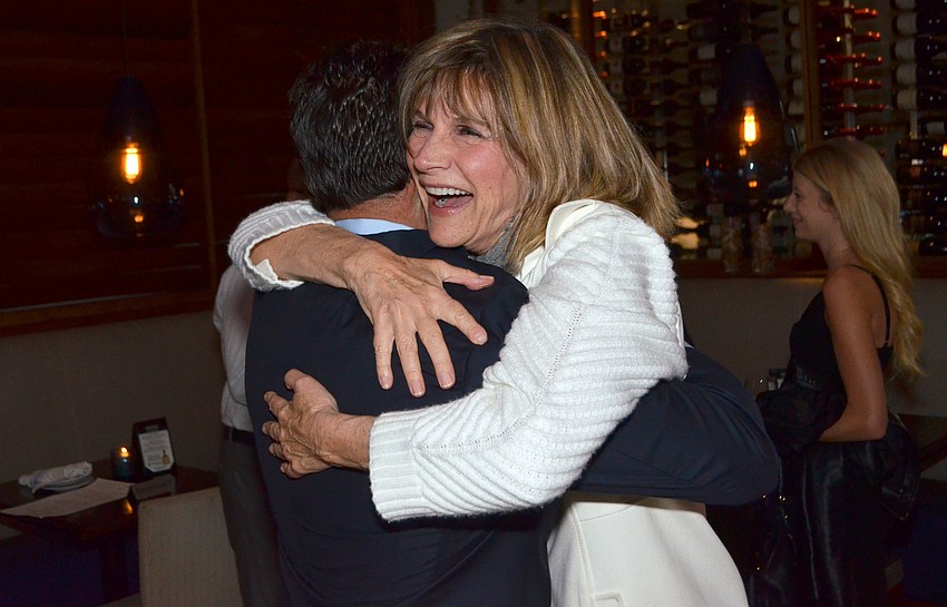 City Commissioner Suzanne Atwell hugs Hagen Brody. Atwell did not seek re-election in this year'  s race.