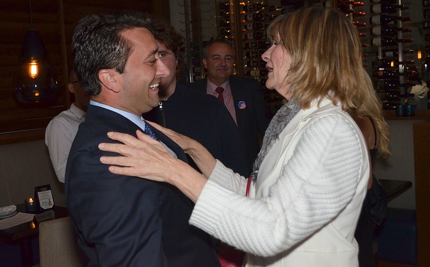 Hagen Brody reacts to the final results with City Commissioner Suzanne Atwell.