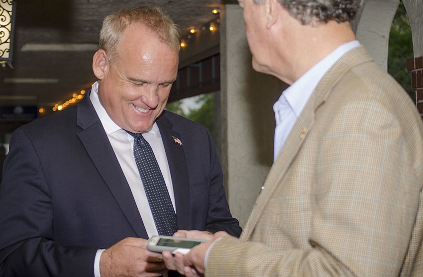Martin Hyde reviews early polling results with supporters. Hyde was one of eight candidates vying for two available seats on the Sarasota City Commission.
