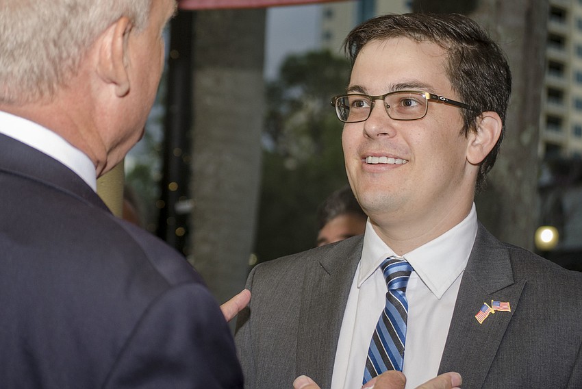 Fellow City Commission candidate Mikael Sandstrom speaks with Martin Hyde about the initial results. Hyde would go on to secure the third slot in the May 9 runoff election.