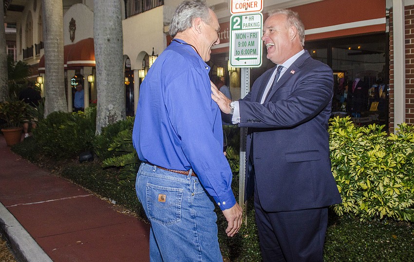 Bob Nikla and Martin Hyde celebrate Hyde advancing to the runoff election. He beat incumbent City Commissioner Susan Chapman by 52 votes.