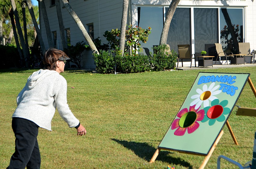 Betty Rahm plays bean bag toss during the Whitney Beach barbecue on March 15.