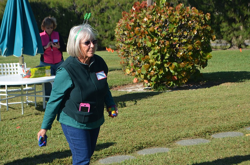 Joyce Tankersley lays bean bag toss during the Whitney Beach barbecue on March 15.