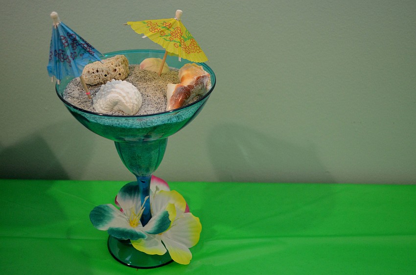 Sand-filled margarite classes sat in the center of each table. They were complete with mini umbrellas, sand and seashells.